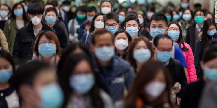 Commuters wearing protective masks walk through Hong Kong Station, operated by MTR Corp., in Hong Kong, China, on Wednesday, Jan. 29, 2020. Governments tightened international travel and border crossings with China as they ramped up efforts to stop the spread of the disease. Photographer: Paul Yeung/Bloomberg via Getty Images