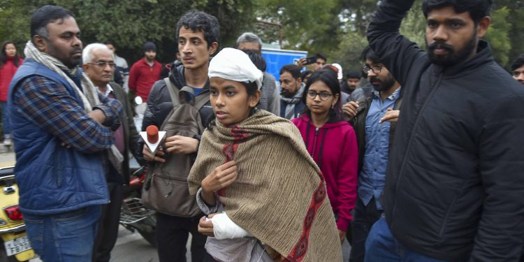 An injured Aishe Ghosh minutes before her press conference Monday