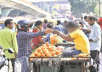 A vendor sells fruits in a polythene bag in Bhubaneswar