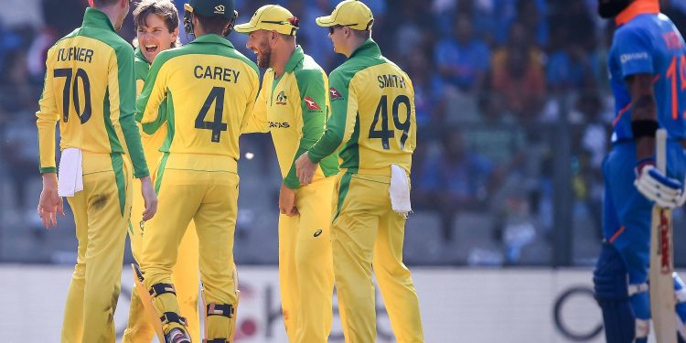 Australian players celebrate with bowler Adam Zampa after Virat Kohli's dismissal, Tuesday