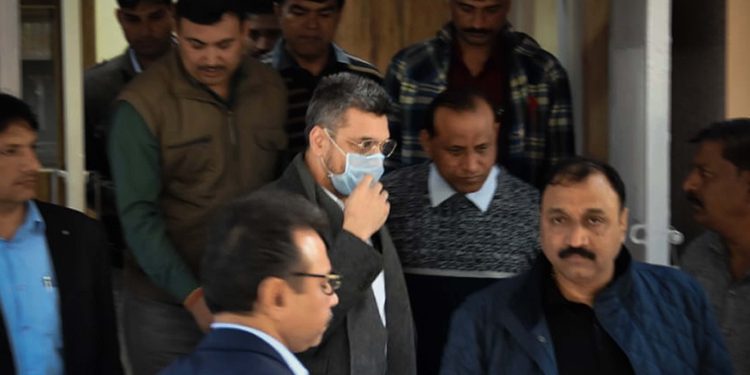 Bookie Sanjeev Chawla (face covered) being escorted out of the Delhi Airport by Crime Branch officers