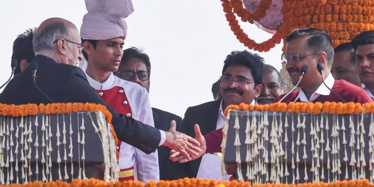 Delhi Lieutenant Governor Anil Baijal congratulates Arvind Kejriwal after the swearing in ceremony