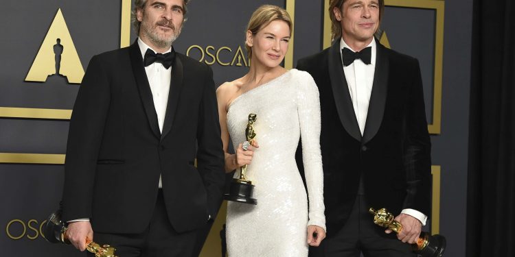 Joaquin Phoenix, winner of the Best Actor award, Renee Zellweger, winner of the Best Actress award and Brad Pitt, winner of the Best Supporting Actor pose in the press room at the Oscars