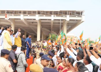 Union Home Minister Amit Shah waves to the crowd outside the BPIA, Friday