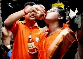 Cow urine being given to a devotee in Kolkata