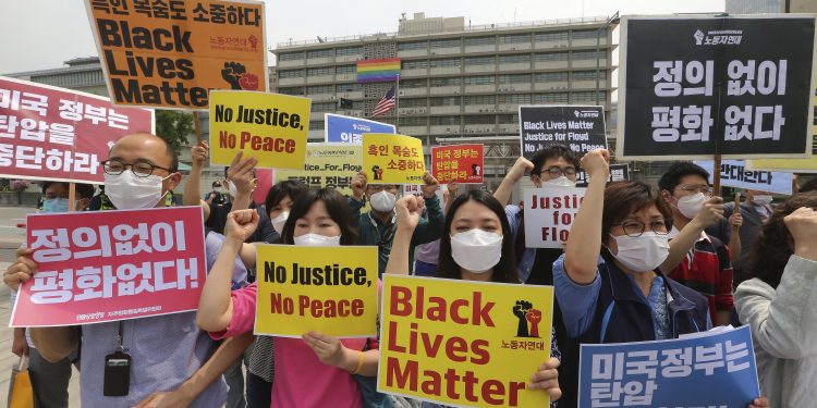 Seoul: South Korean protesters shout slogans during a protest over the death of George Floyd, a black man who died after being restrained by Minneapolis police officers on May 25, near the U.S. embassy in Seoul, South Korea, Friday, June 5, 2020. The signs read "The U.S. government should stop oppression and there is no peace without justice." AP/PTI