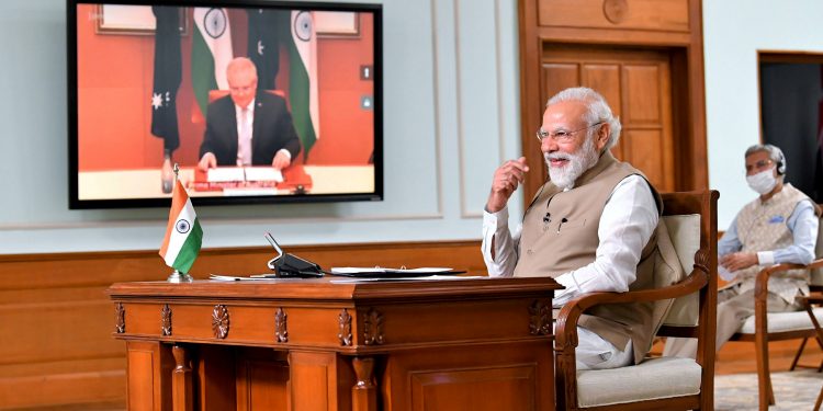 New Delhi: Prime Minister Narendra Modi during his first-ever virtual summit with his Australian counterpart Scott Morrison (on the screen), In New Delhi, Thursday, June 4, 2020. (PIB/PTI Photo)