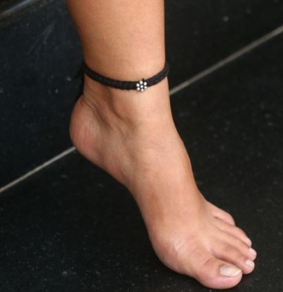 Is wearing a black thread on feet equal to promoting superstition? - Quora