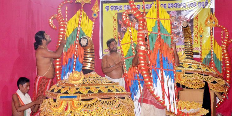 Artisans giving finishing touches to the special attire for Nagarjuna Besha Ritual