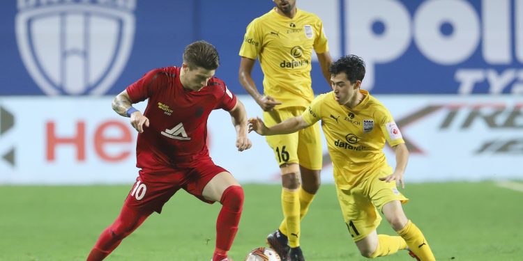 NEUFC's Federico Gallego and MCFC's Cy Goddard in action in match 2 of ISL 7 at the Tilak Maidan Stadium, Vasco. Pic - IANS