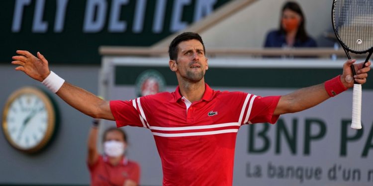 On top of the world: Novak Djokovic is all pumped up after winning the French Open men’s singles crown Sunday in Paris  (PTI Photo)