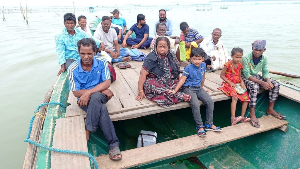 Health workers carry Covid-19 swab samples on passenger boats