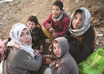 Children eat bread at the Wazir Akbar Khan hill in Kabul. (AFP)