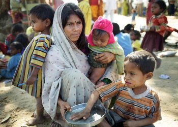 Anita Devi sits with her three children (LtoR) Sandeep, Sanjit and Deepak (eating the school-provided midday meal). Like many of the men from Jalhe Bogiya village, Anita's husband Sukhdev Mandal works at a brick kiln for 4-5 months a year. Lack of irrigation and food security lie at the root of the Maha Dalit community's problems in the village of Jalhe Bogiya. In the exploitative and divisive caste system, Maha Dalits are considered the lowest of the low. Ostracized by wider society (including the administration) illiteracy runs as high as 95 percent. Thanks to Oxfam-supported intervention, Jalhe Bogiya now has an - as yet incomplete - access-road built as part of the NREGA (National Rural Employment Guarantee Scheme). And an Oxfam-supported initiative in summer 2010 successfully lobbied the local administration to implement the provision of school midday meals which, by law is the right of every child. It is alleged that the Anganwadi (pre-school) centre administrator, syphons off food meant for young children. Jalhe Bogiya has several hand pumps supplying water but these do not work between the months of May to October. And though the village was connected to the electricity grid six months ago, power-supply is not reliable. Without land-ownership and only irregular agricultural work from which to earn an income, the Maha Dalits of Jalhe Bogiya frequently migrate in search of labour at stone breaking quarries, brick-kilns or undertake menial household work in the homes of the urban middle class in far-away cities. Photo: Tom Pietrasik Mohanpur Block, Gaya District, Bihar. India February 23rd 2011