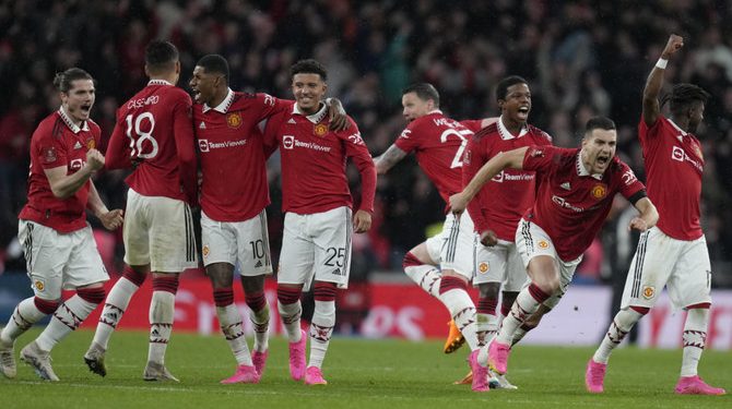 Manchester United players celebrate after winning the English FA Cup semifinal soccer match between Brighton and Hove Albion and Manchester United at Wembley Stadium in London, Sunday, April 23, 2023. (AP Photo/Kirsty Wigglesworth)