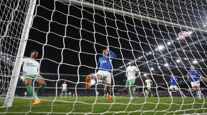 Newcastle's Jacob Murphy, left, scores his side's fourth goal during the English Premier League soccer match between Everton and Newcastle United at the Goodison Park stadium in Liverpool, England, Thursday, April 27, 2023. (AP Photo/Jon Super)