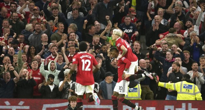 Manchester United's Marcus Rashford celebrates after scoring his side's fourth goal during the English Premier League soccer match between Manchester United and Chelsea at the Old Trafford stadium in Manchester, England, Thursday, May 25, 2023. (AP Photo/Dave Thompson)