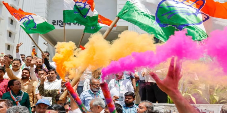 Congress workers celebrate at the party office after the party’s victory in the Karnataka Assembly elections, outside Rajiv Gandhi Bhawan in Ahmedabad (PTI Photo)