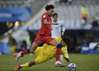 England's Samuel Edozie, front, runs with the ball as Iraq's goalkeeper Hussein Hasan tries to stop him during a FIFA U-20 World Cup Group E soccer match at the Diego Armando Maradona stadium in La Plata, Argentina, Sunday, May 28, 2023. (AP Photo/Gustavo Garello)