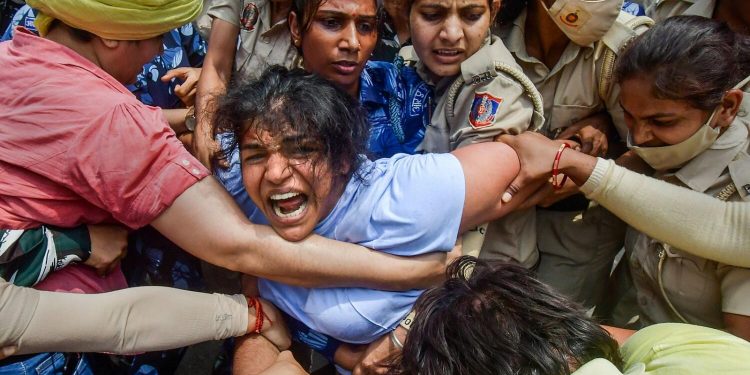 Security personnel detain wrestler Sakshi Malik during their protest march towards new Parliament building in New Delhi. (File: PTI)