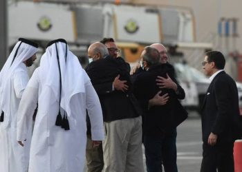 US citizens Siamak Namazi, right, Emad Sharghi, third left, and Morad Tahbaz, second right, after landing in Doha, Qatar. (EPA)