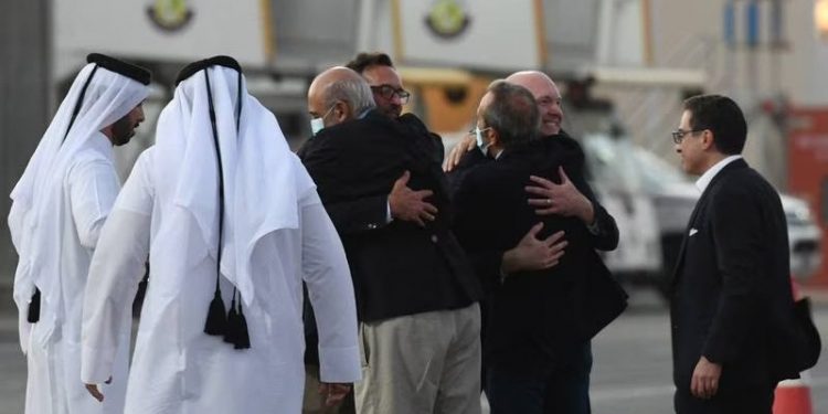 US citizens Siamak Namazi, right, Emad Sharghi, third left, and Morad Tahbaz, second right, after landing in Doha, Qatar. (EPA)