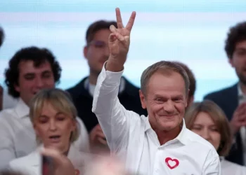 Donald Tusk, leader of the opposition grouping Civic Coalition (KO), celebrated exit poll results in Poland's parliamentary election on Sunday, October 15 [Kacper Pempel/Reuters]