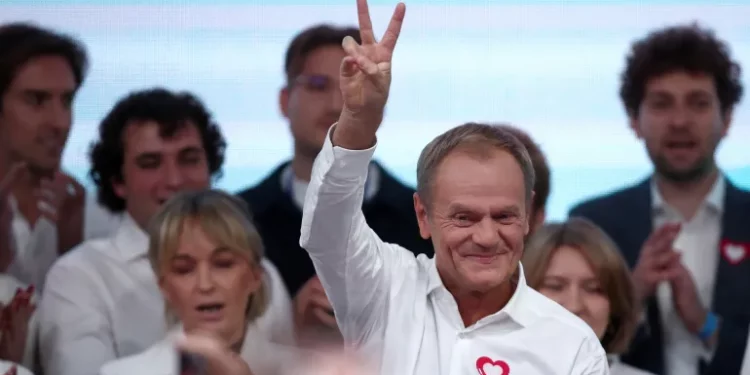 Donald Tusk, leader of the opposition grouping Civic Coalition (KO), celebrated exit poll results in Poland's parliamentary election on Sunday, October 15 [Kacper Pempel/Reuters]