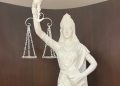 Supreme Court's Lady Justice now holds constitution, not sword; loses blindfold