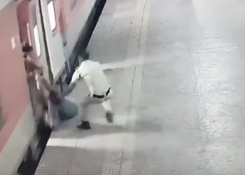 Watch video: Woman nearly pulled under moving train, then comes railway cop with quick reflexes!